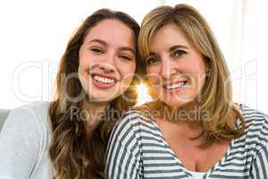Mother and daughter smiling