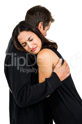 Unhappy couple embracing