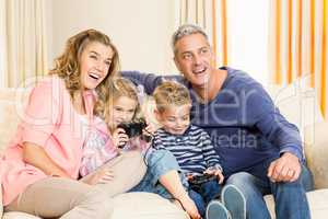 Happy family enjoying video games together