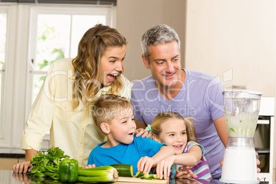 Happy family preparing healthy smoothie