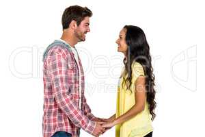 Smiling couple holding hands and looking at each other