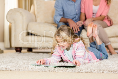 Happy family lying together on the floor