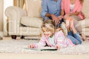 Happy family lying together on the floor