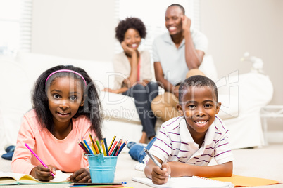 Happy kids using colouring books