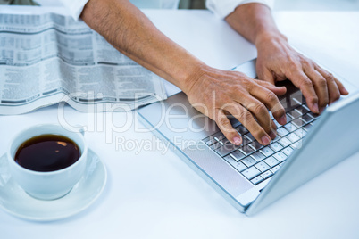 Businessman typing on his computer