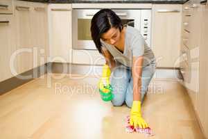 Attractive brunette cleaning the floor