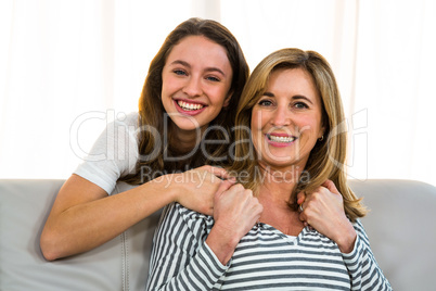 Mother and daughter smiling