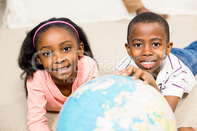 Close up of kids using a world globe