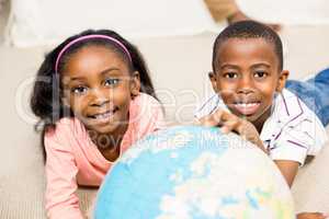 Close up of kids using a world globe