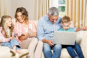 Happy family using different tech items