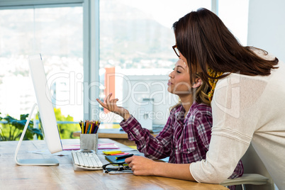 Two girls work at office