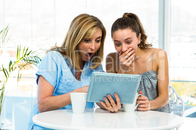 Mother and daughter watch tablet