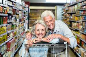 Happy senior couple with cart