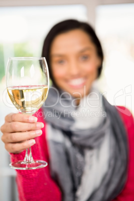 Glass of white wine against smiling brunette