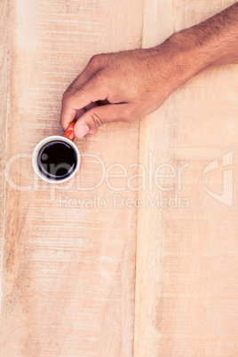 Overhead view of businessman holding black coffee
