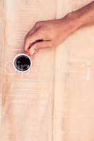 Overhead view of businessman holding black coffee