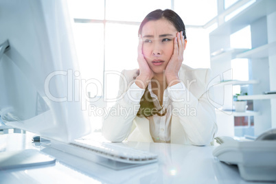 Stressed businesswoman working at her desk