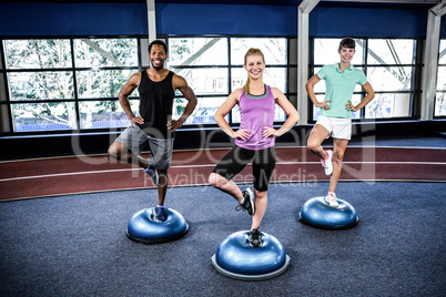 Fit people doing exercise with bosu ball