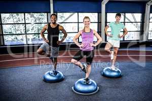 Fit people doing exercise with bosu ball