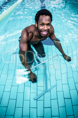 Fit man cycling in the pool