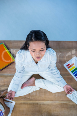 Peaceful businesswoman doing yoga sitting on floor