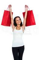 Smiling woman holding red shopping bags