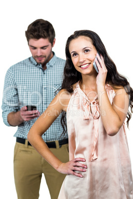 Smiling couple using smartphones