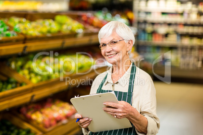 Smiling senior worker with clipboard