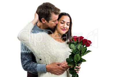 Man embracing and kissing girlfriend