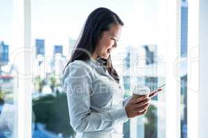 Smiling businesswoman using smartphone