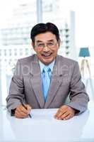 Happy businessman on his desk