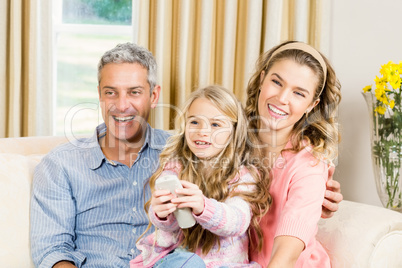 Happy family using remote control