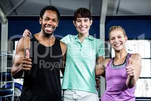 Muscular smiling people standing together