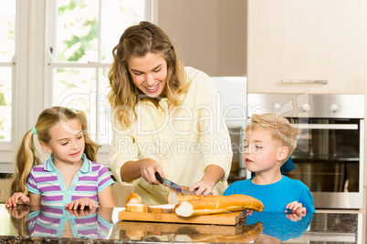 Happy family slicing bread