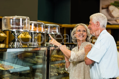 Senior couple pointing puddings