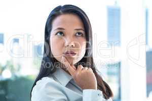 Thoughtful businesswoman with finger on chin