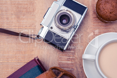 Directly above shot of old camera with diaries and coffee