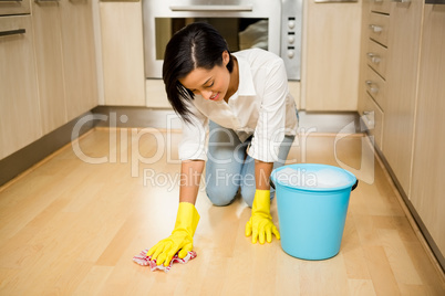 Attractive brunette cleaning the floor