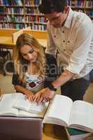 Smiling students working together while sitting at table