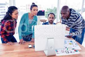 Business team in front of computer at desk