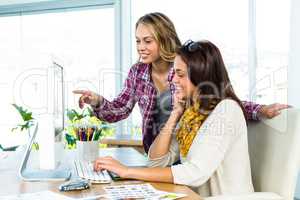 Two girls use a computer