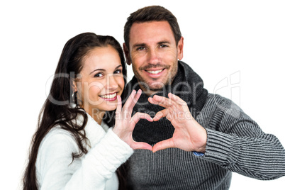 Smiling couple making heart shape with hands