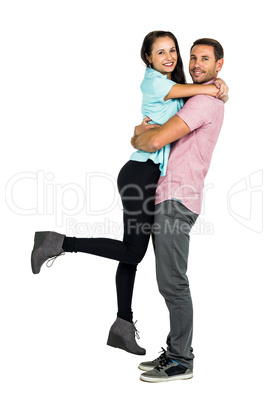 Full length of portrait of smiling couple hugging