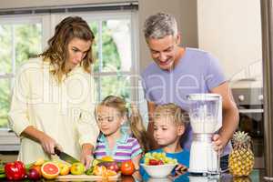 Happy family preparing healthy smoothie