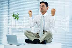 Peaceful asian businessman relaxing