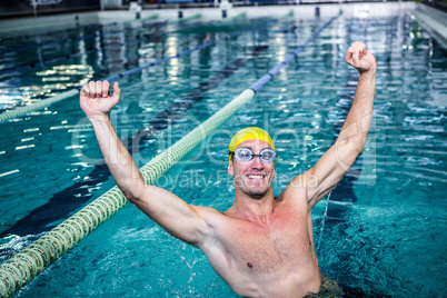 Happy swimmer put his hands up
