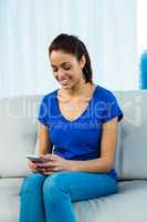 Smiling woman using smartphone