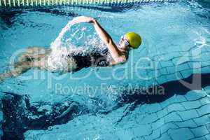 Fit female swimmer doing the back stroke
