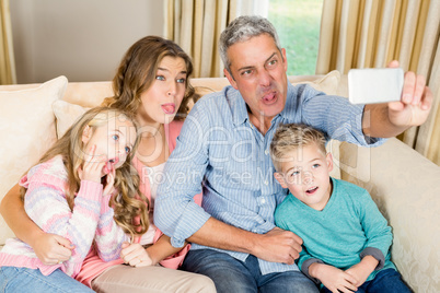 Happy family taking selfie on the sofa Happy family taking selfie on the sofa