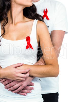 Couple hugging with red ribbons